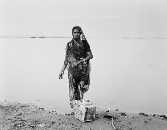 Woman with Offerings on Ganges Riverbank, Chaat Festival, 1993. India. copyright photographer Marilyn Bridges